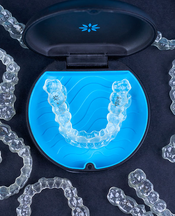 Clear aligners on black background.